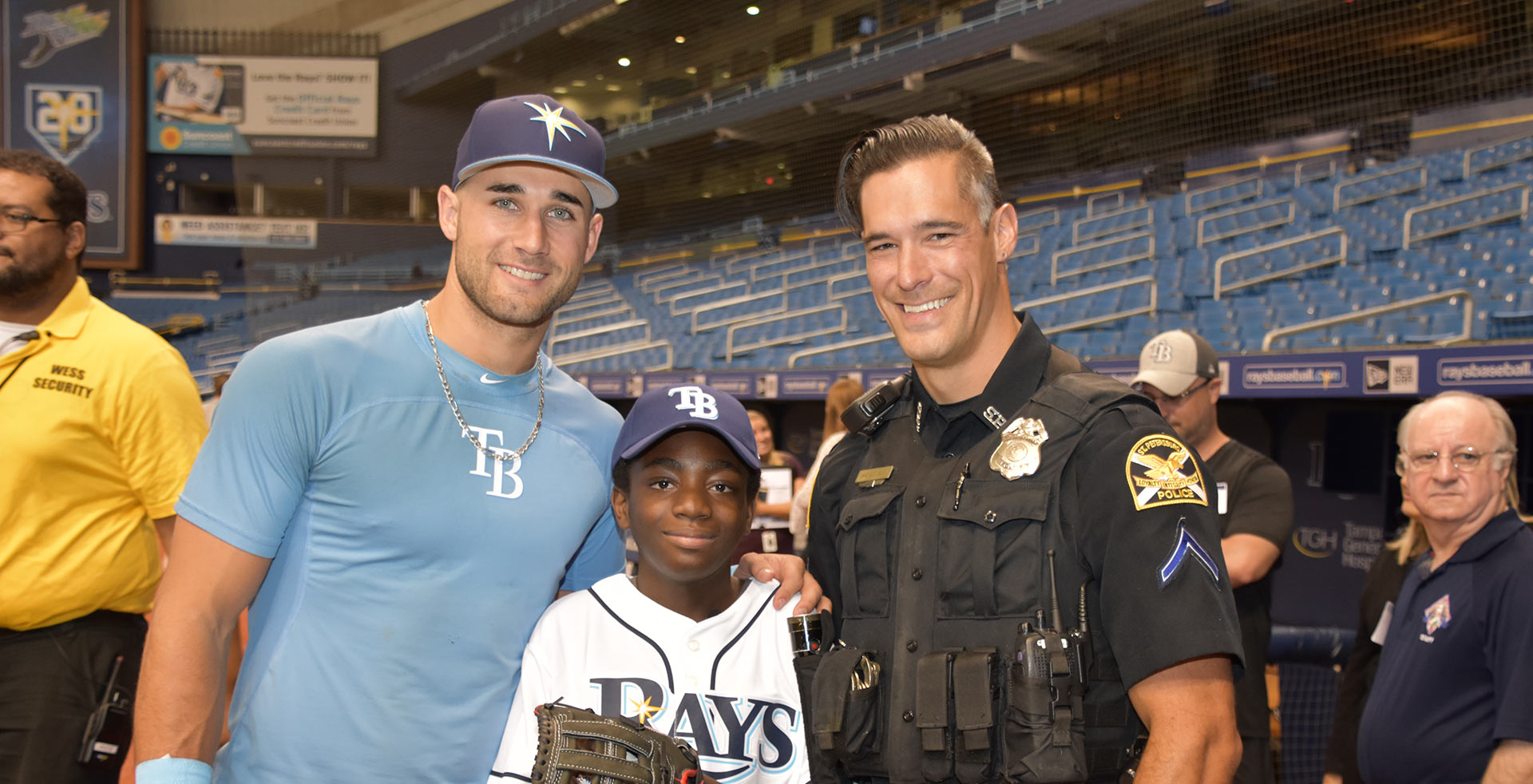 Officer and Tampa Bay Rays player with child