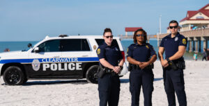 Officers on beach with vehicle