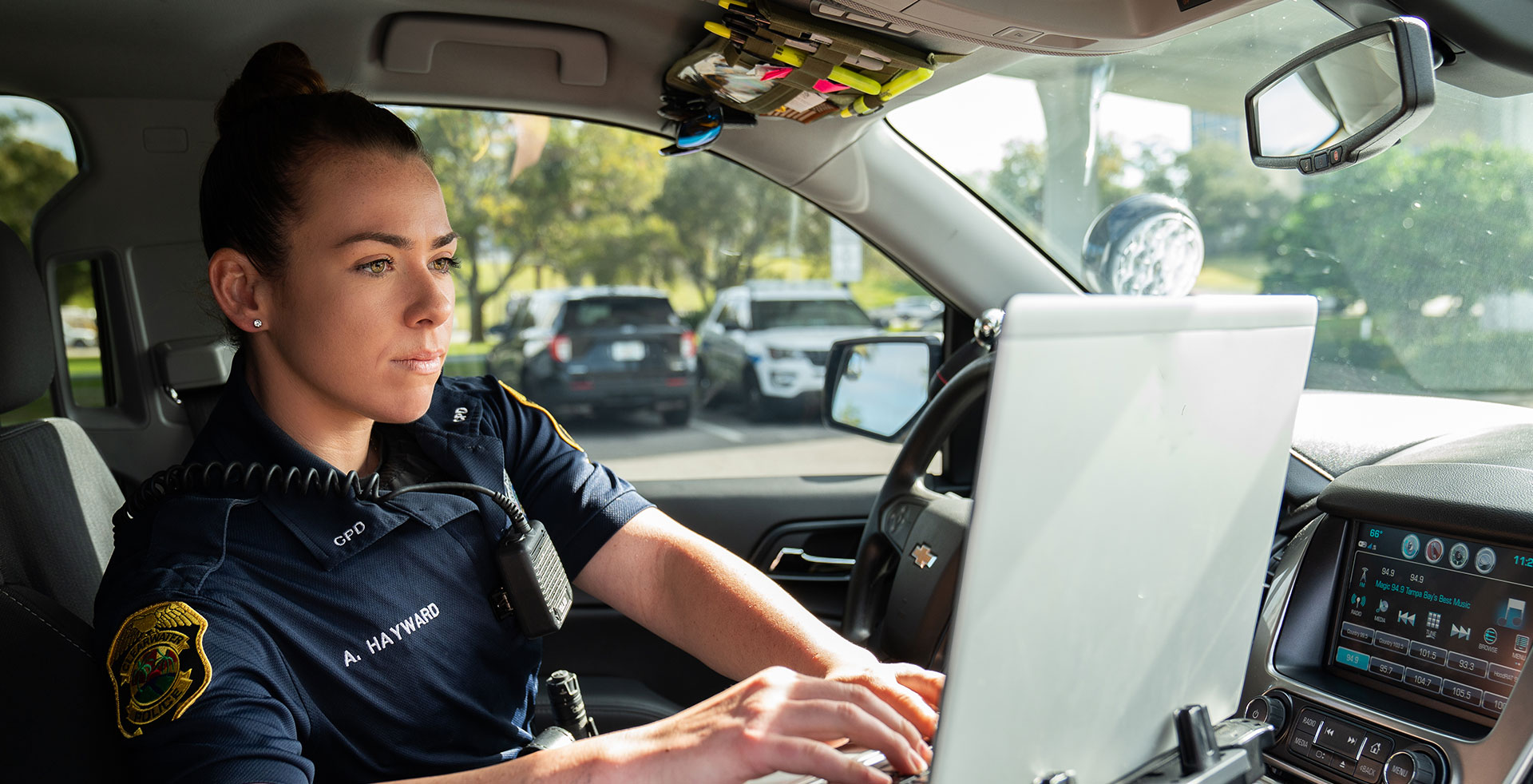 Officer at computer in patrol car
