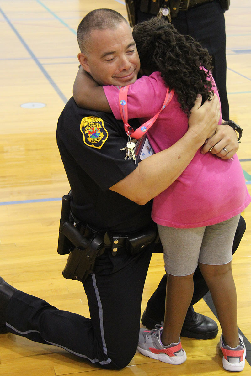 officer hugging a child