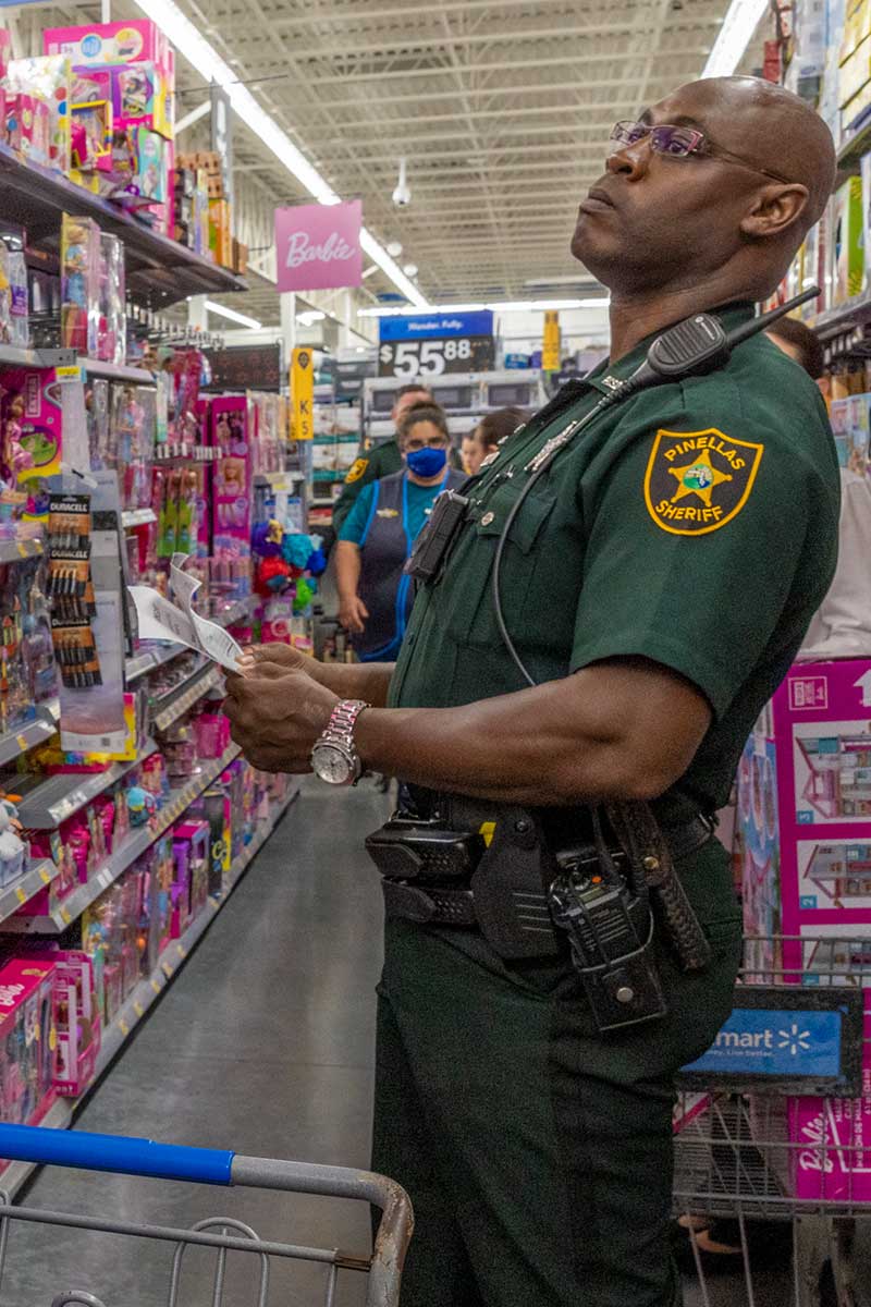 Officer choosing gifts for Toys for Tots drive